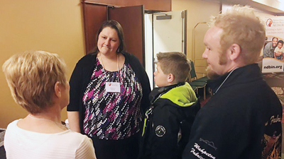 Rebecca Quinn, center, speaks with the Medenwalds.